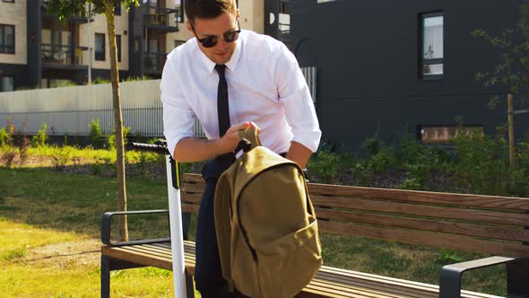 Businessman with Backpack Riding Electric Scooter