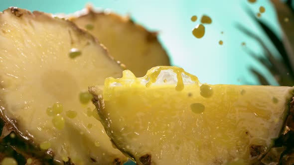 Slow Motion Shot of Pineapple and Juice Splashing Through Pineapple Slices