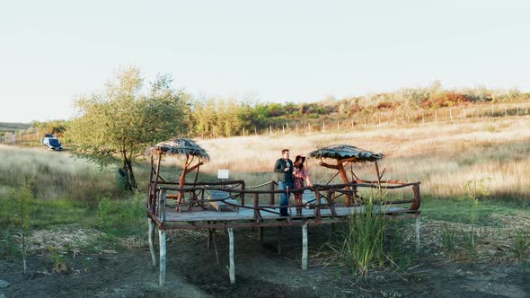 Couple Enjoying a Glass of Wine on a Pontoon in a Rural Are