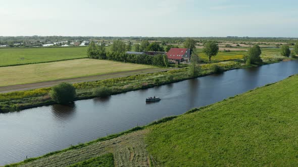 Calm River With Sailboat In Scenic Countryside In Ossenzijl, Friesland, Netherlands. Aerial Drone Ro