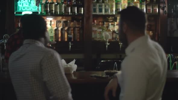 Bartender serving beer for colleagues