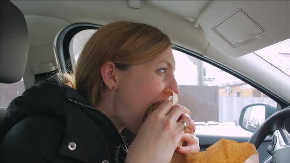 Woman Eating Fast Food In The Car