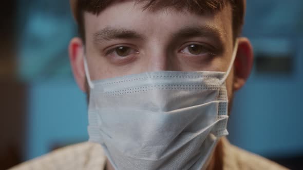 Portrait of Young Man with Brown Eyes Wearing Medical Protective Mask for Prevention Coronavirus