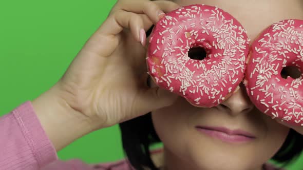 Happy Beautiful Young Girl Posing and Having Fun with Donuts. Chroma Key