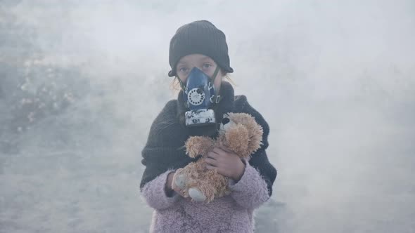 Portrait of Child in Protective Mask Standing in Clouds of Toxic Smoke