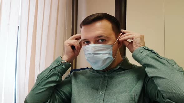 Portrait of man wearing protective face mask to prevent covid infection