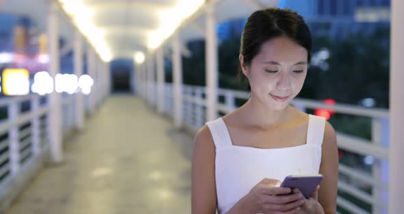 Woman use of mobile phone at night