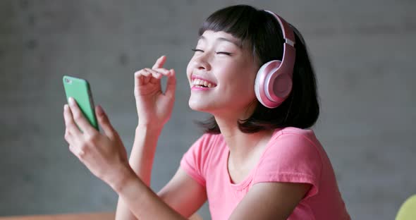 Woman enjoy music on headphone at home