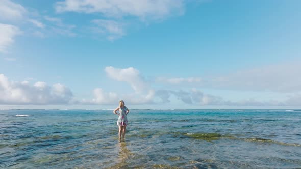 Cinematic Aerial Around Woman in Water with Cinematic Blue Sky Motion Background