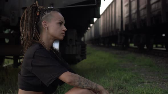 Young Woman on the Railroad Looks at the Train