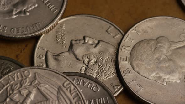 Rotating stock footage shot of American quarters (coin - $0.25)