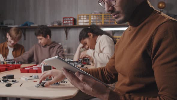 Robotics Teacher Checking Something In Internet