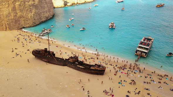 Aerial drone view of the Navagio beach on the Ionian Sea coast of Zakynthos, Greece. Moored boat