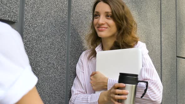 Female Portrait of Young Woman with Silver Laptop and Cup of Coffee Waiting for a Meeting Near Dark