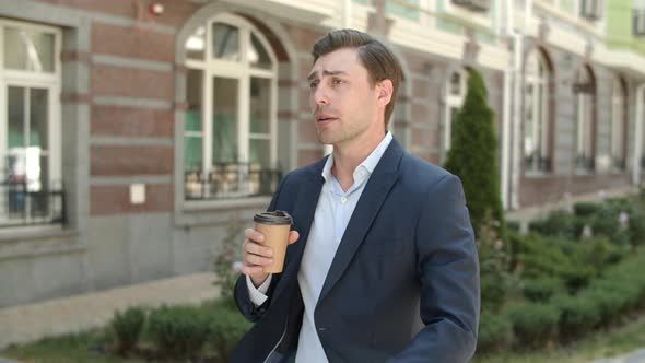 Man Drinking Coffee Before Work. Businessman Looking at Smart Watch