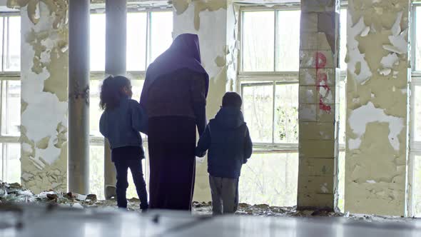 Female Refugee with Children in Abandoned House