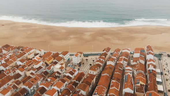 Span Over European City with Ocean View, Tiled Brown Roofs Slow Motion