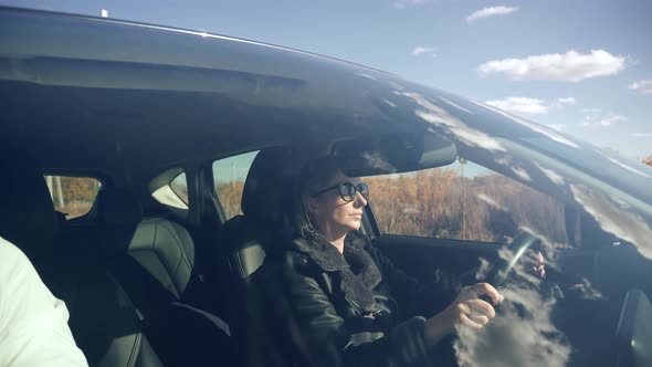 Car Owner Hold Steering Wheel Enjoy Traveling Road Route. Confident Girl Driving Expensive Car.