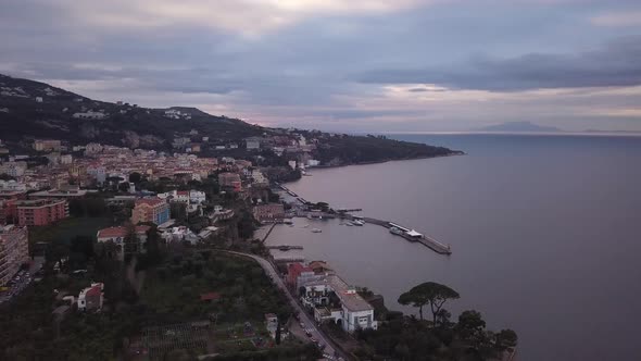 The coastal town of Sorrento in Italy at sunset or sunrise, a beautiful landscape of houses near the