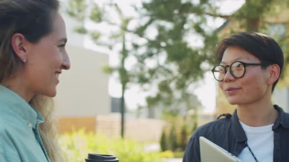 Multiethnic Coworkers Having Discussion Outdoors