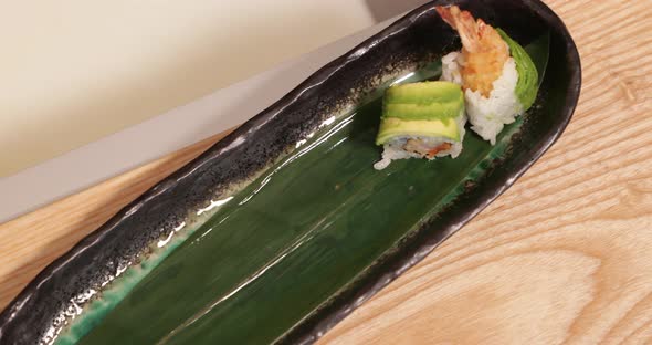 Itamae Chef Placed And Arranged Sushi Rolls On The Ceramic Plate. - high angle shot