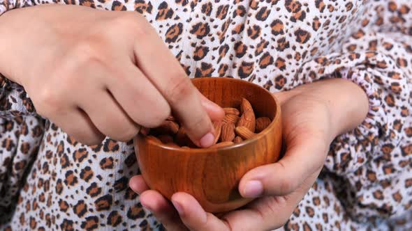 Close Up Women Hand Holding a Bowl on Almond 