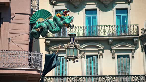 Dragon statue on the facade of an old building in Barcelona, Spain