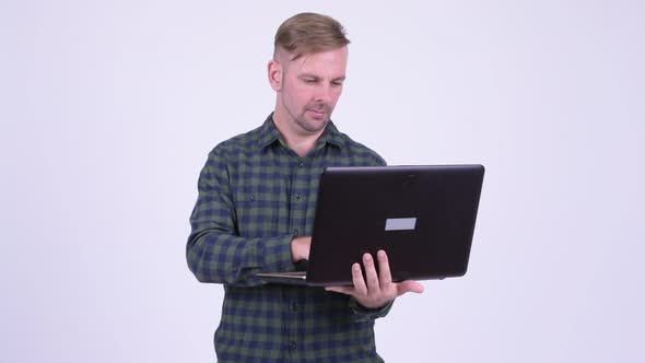 Portrait of Happy Blonde Hipster Man Using Laptop