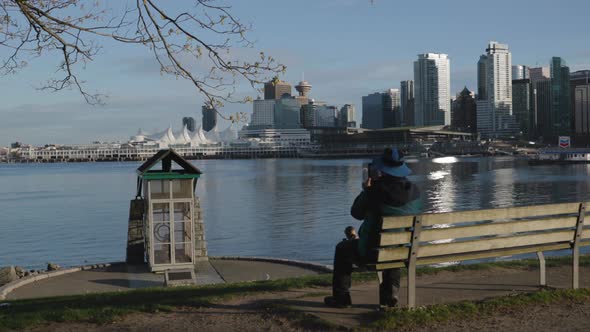 Man filming the Vancouver Cannon Blasts in Stanley Park