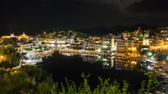 Time lapse of Night Greek city. Landscape  lake Voulismeni and Agios Nikolaos town at nigh