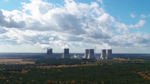 Cooling Towers of Nuclear Power Plant with Cloudy Sky in the Background Aerial View