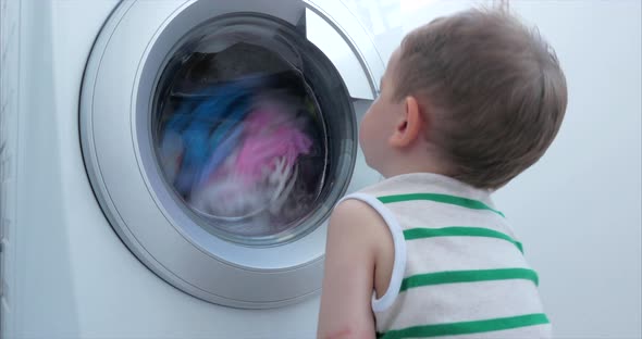 Cute Child Looks Inside the Washing Machine