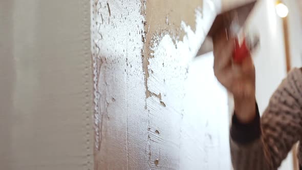 Male Caucasian Middleaged Worker Laying on and Levelling Liquid Cement on Wall in Slowmotion