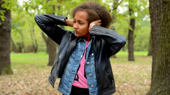 Young Beautiful Upset Girl Blocked Her Ears with Hands - She Is Fed Up with Noise in the Forest