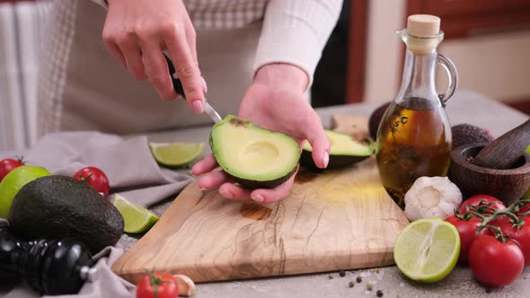 Healthy Vegetarian Food  Woman Peeling Avocado Half with a Spoon