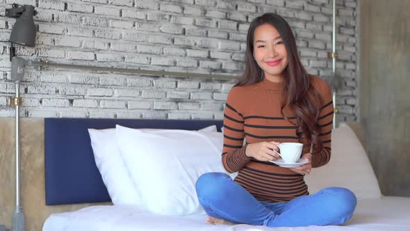 Young asian woman with coffee cup