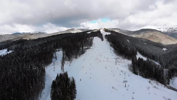 Aerial View on Ski Slopes with Skiers and Ski Lifts on Ski Resort in Winter