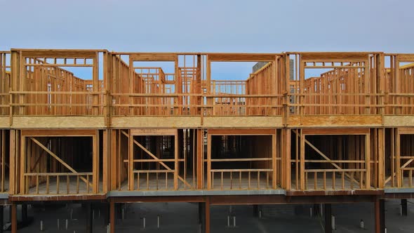 Unfinished Wood Framing Complex Construction Site with Wooden Framework of Urban Apartment