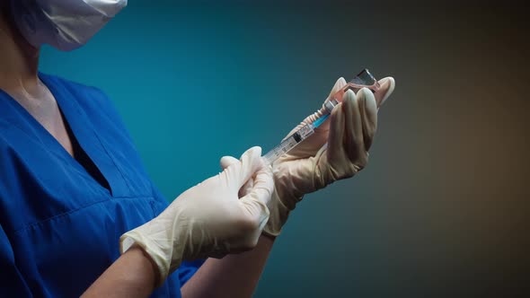Doctor Filling Syringe with Solution