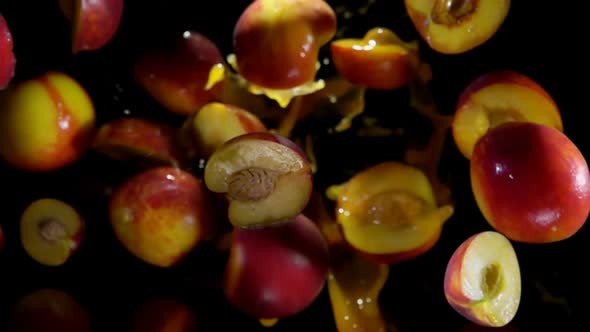 Halves of the Fresh Ripe Peach Are Bouncing with the Drops of Juice