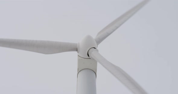Large wind turbines with blades in field wind park slow motion