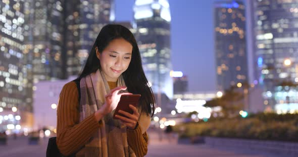 Asian woman use of smart phone at night