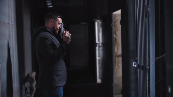 Adult Man Playing with Guns in Shooting Gallery