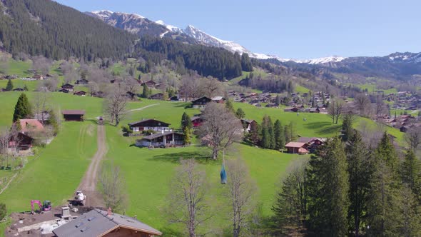 Drone Shot of Helicopter Carrying Cargo in the Swiss Mountains