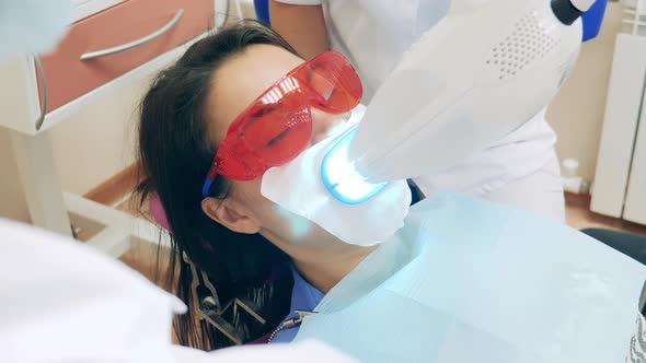 A Woman is Undergoing a Dental Hygienic Procedure