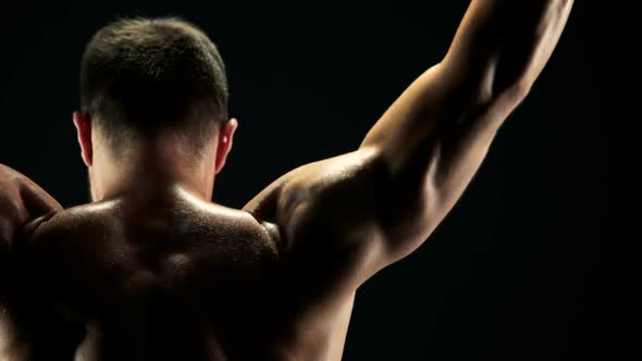 Rear View Muscular Man Exercising with Barbell