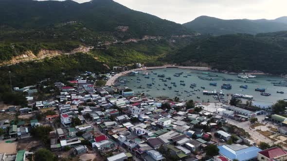 A village under the mountains is located near VInh Hy bay. Fishermen's boats are anchored along the