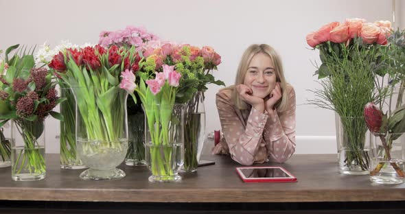 Charming Girl Florist Use A Tablet And Looking Into The Camera