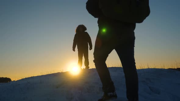 Alpinist Travels Hiking. a Traveler Climbs a Snowy Mountain, Tourists Meet on a Hilltop 