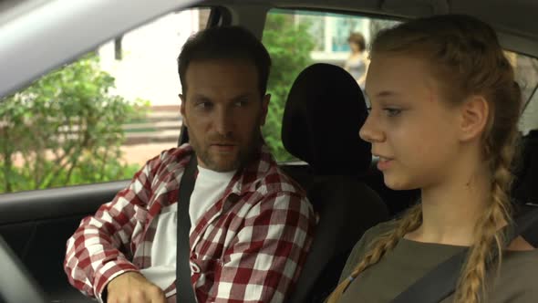 Caring Father Teaching Young Daughter to Drive Automobile